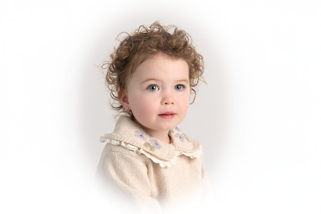 Sweet heirloom portrait of a little girl with beautiful eyes and curly hair